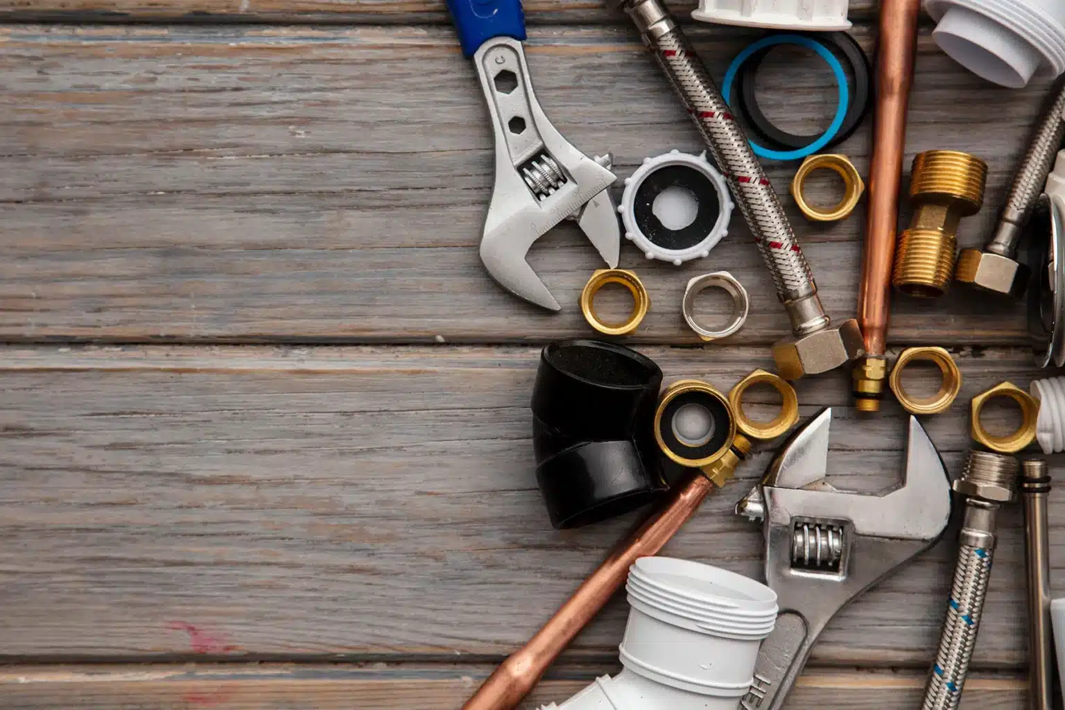 plumbing tools on a wooden background